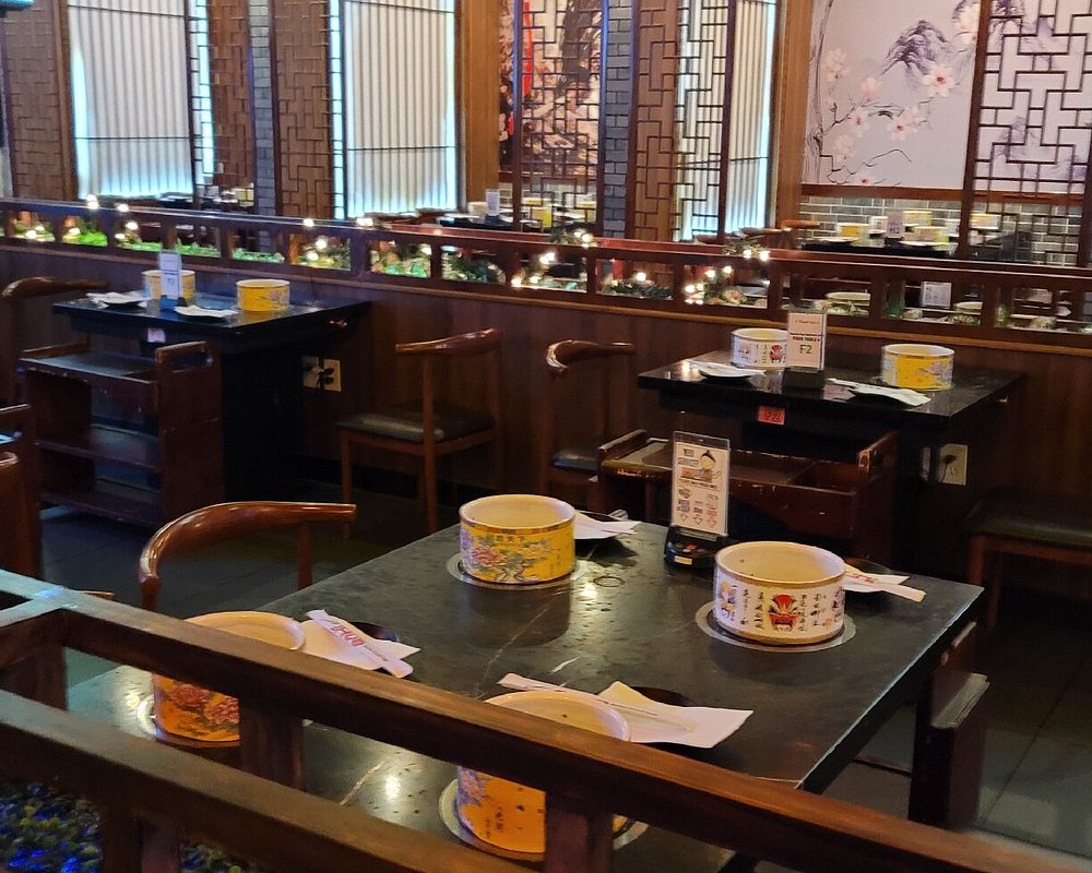 Hot Pot King’s dining room, with individual hot pot burners at wooden tables